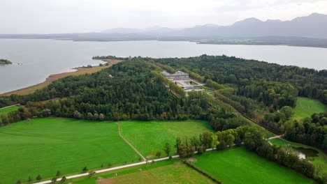 Una-Vista-De-Herrenchiemsee-Encaramado-A-Orillas-Del-Lago-Chiemsee-En-Baviera,-Alemania---Drone-Volando-Hacia-Adelante