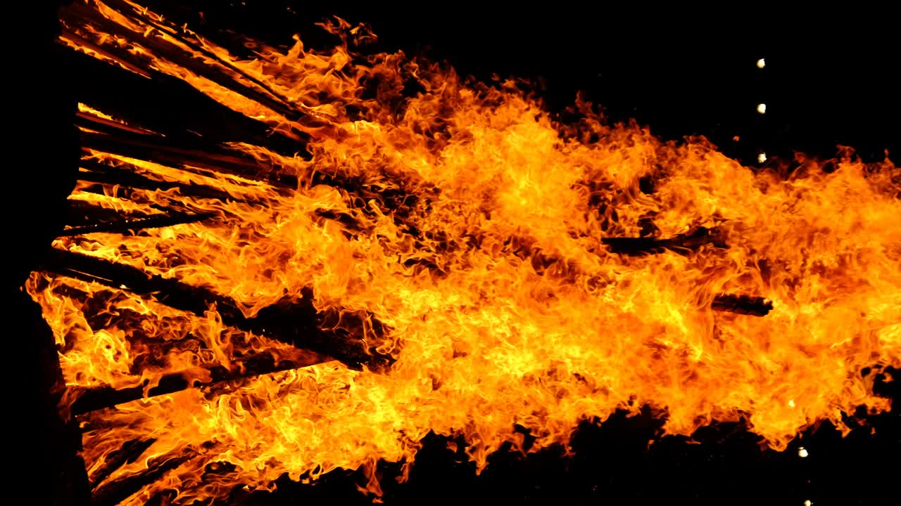 video hoguera vertical quema por la noche en un fondo negro en la naturaleza