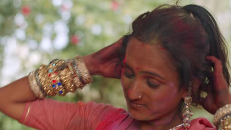 indian women close-up of face smeared with bright holi colors