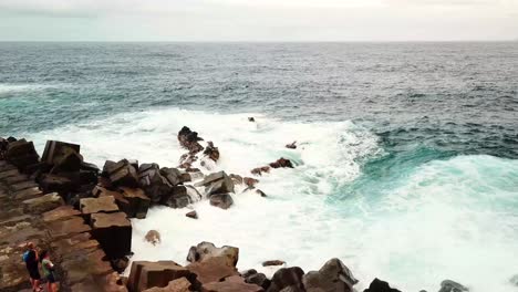 foaming ocean waves crashing against rugged rocky coast of seixal, northern madeira island, portugal, create stunning seascape, showcasing nature's raw power, slow motion shot