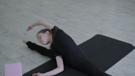 young ballet girl at studio lesson. training performance. stretching exercise pose. ballerina practice balance technique. classical elegance fitness.