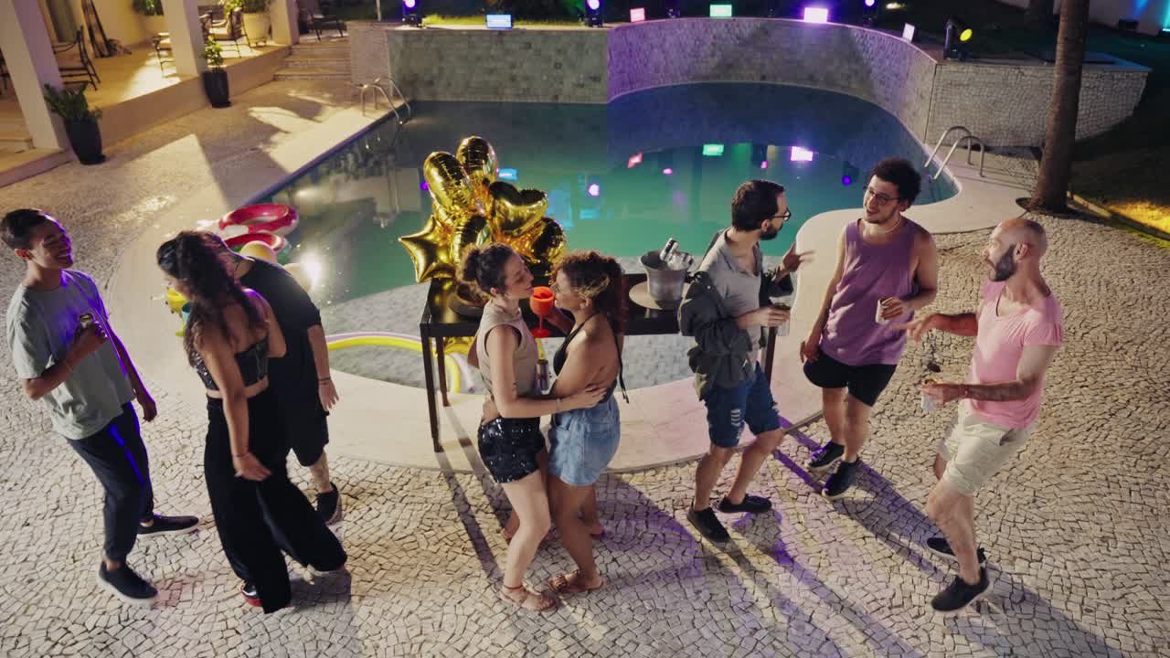Friends Enjoying a Vibrant Nighttime Pool Party
