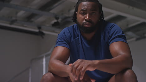 Portrait-Of-Determined-Male-Athlete-Sport-Training-In-Gym-Sitting-And-Concentrating-In-Changing-Room-With-Focused-Expression-9