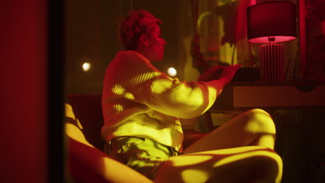 woman with camera in a night interior
