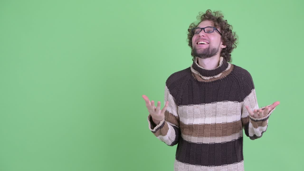 Young handsome bearded man with curly hair
