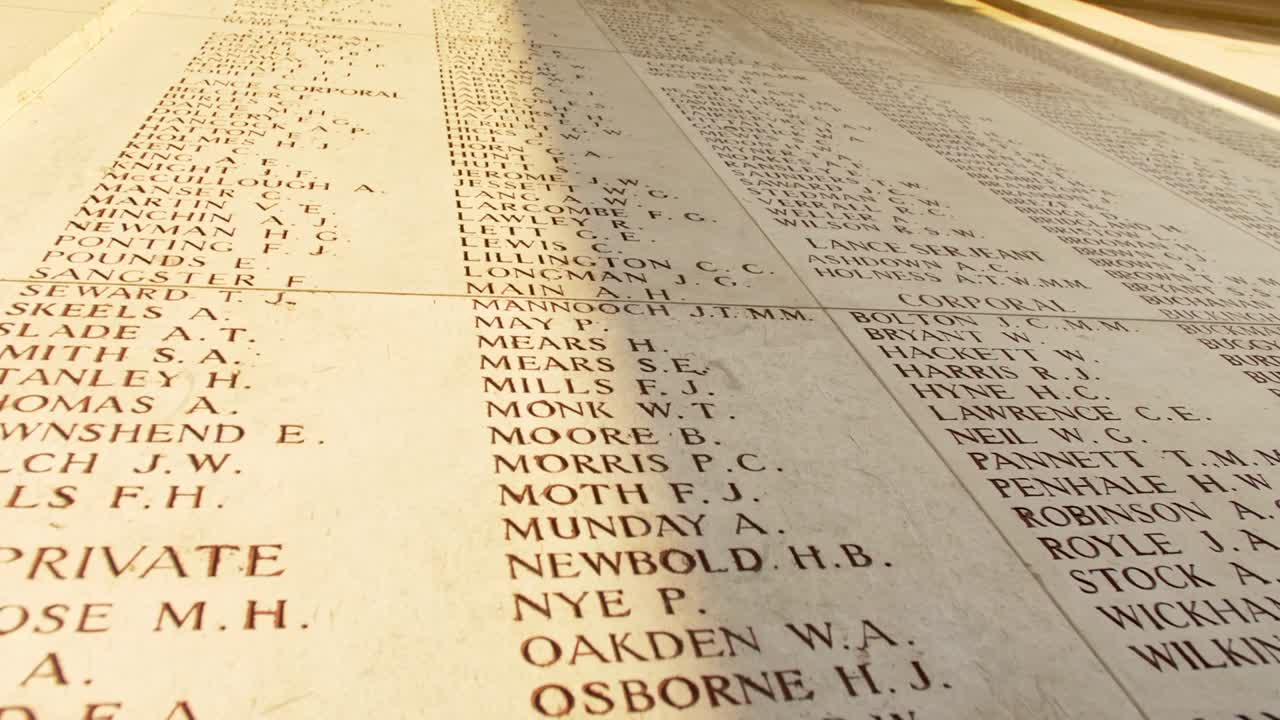 Names of Fallen Soldiers at a War Memorial Cemetery in Ypres Belgium, handheld drifting shot