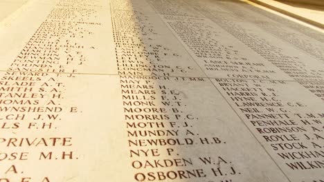 names of fallen soldiers at a war memorial cemetery in ypres belgium, handheld drifting shot