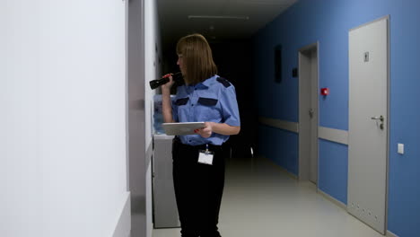 Woman-in-uniform-searching-on-the-hallway