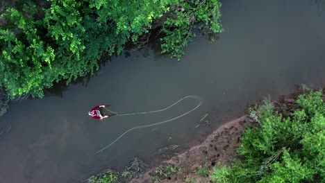 fly fishing aerial. angler stands in the narrow river and casts the fly with fishing rod