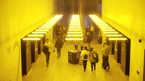 yellow illuminated corridor with people