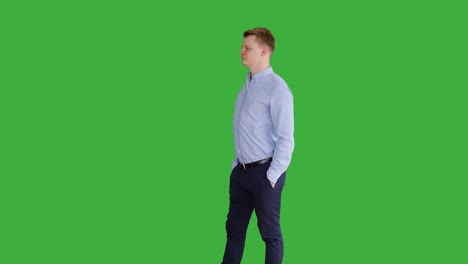 young caucasian man standing against green screen background. male person isolated on chroma key. casual business professional portrait