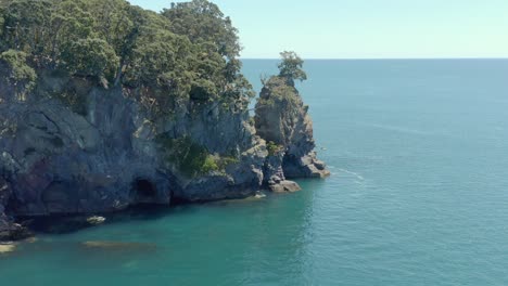 steep rock wall cliffs of moutohora whale island in new zealand, aerial