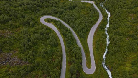 serpentine road at geiranger fjord, norway. curves, twists and turns. car driving along narrow street