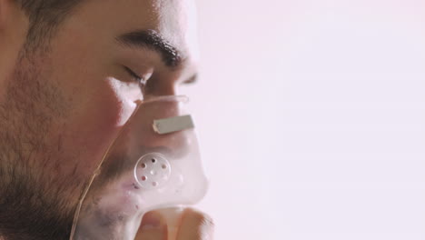 close up of a sick man breathing through oxygen mask 2