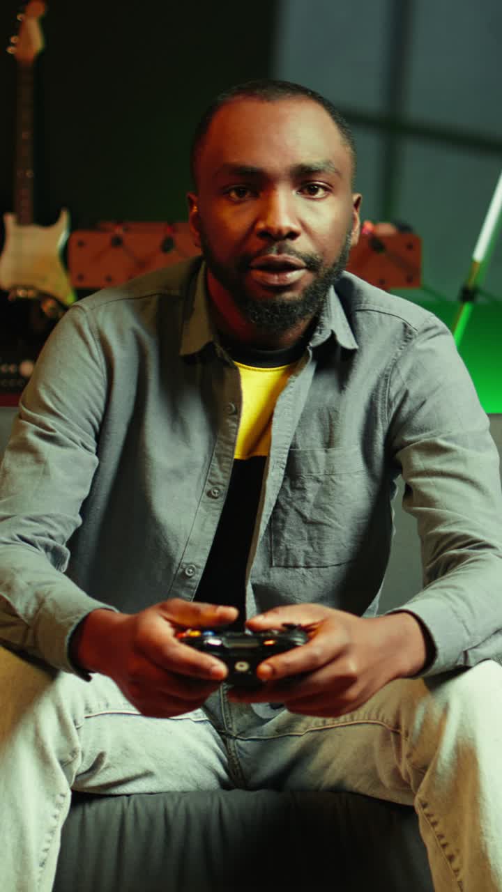 Vertical video Man arriving home, gaming and enjoying leisure time on couch