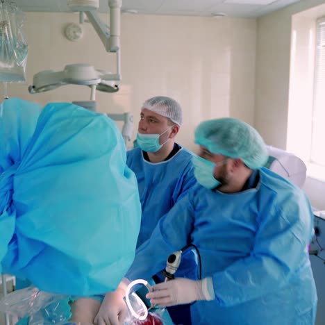 surgical procedure. professional doctors in medical uniform work in the modern operating room on medical equipment background.