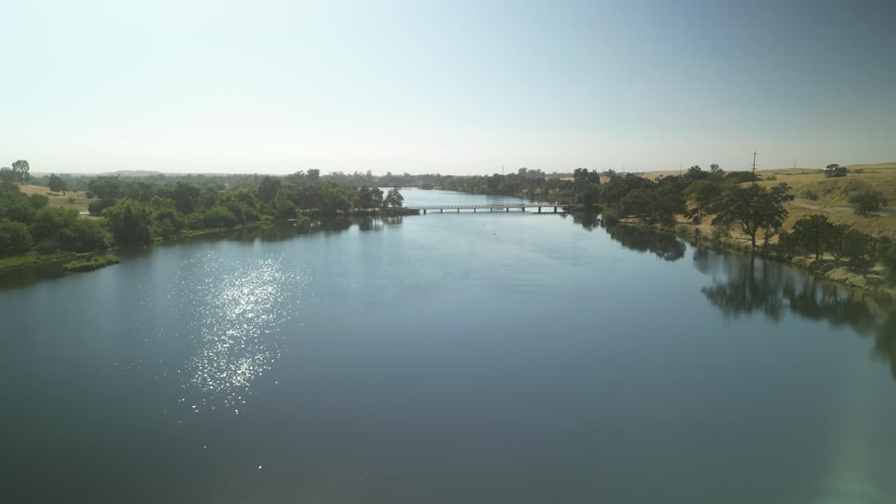 Serene Lake with Bridge and Lush Greenery