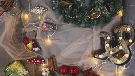 creative hobby. gift wrapping. packaging modern christmas present boxes in stylish gray paper with satin red ribbon. top view of hands on white wood table with fir tree branches, decoration