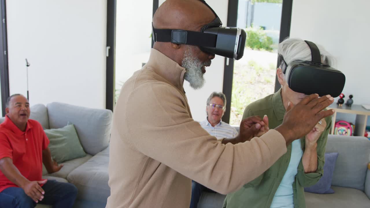 Happy senior diverse people using vr headsets at retirement home