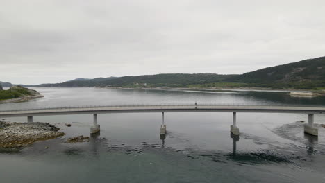 aerial flyover bridge crossing fjord near bodo city during cloudy day in norway