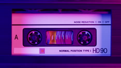 close-up of a vintage cassette tape with vibrant neon lighting