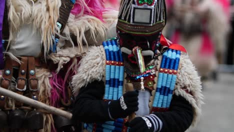 bulgarian kid kuker coming out and then in and then out of focus again with a beads costume