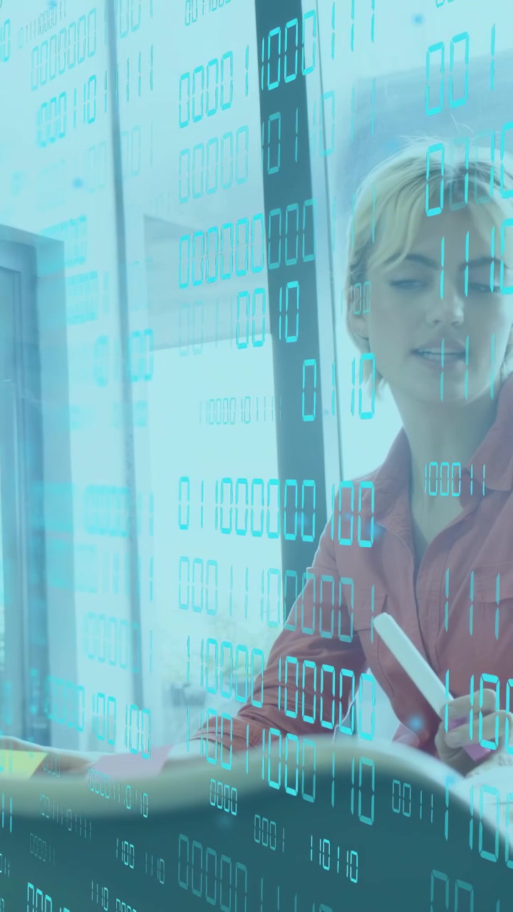 Vertical video: Left woman gesturing, causing cyan bits overlay while right noting for business