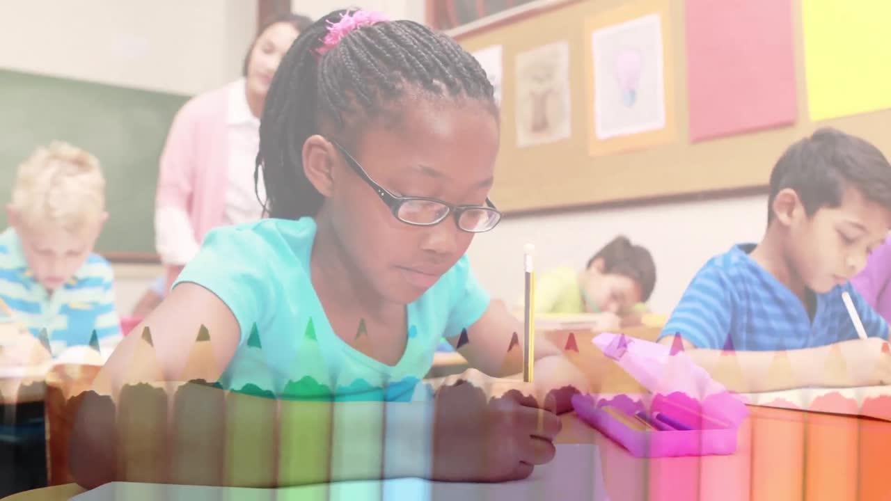 Animation of crayons over happy african american girl learning at school with diverse pupils