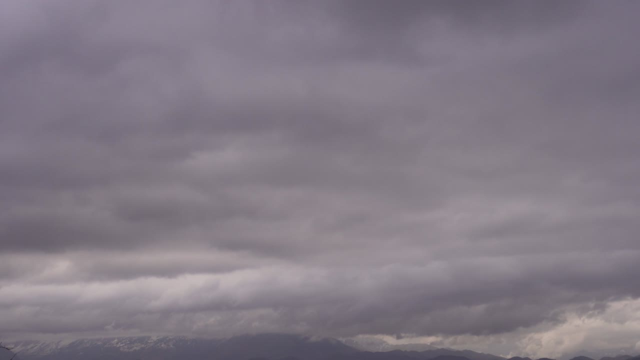 눈 인 산꼭대기 위의 비 구름은 천천히 움직입니다.