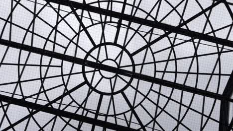 looking up at geometric style glass ceiling rotating shot