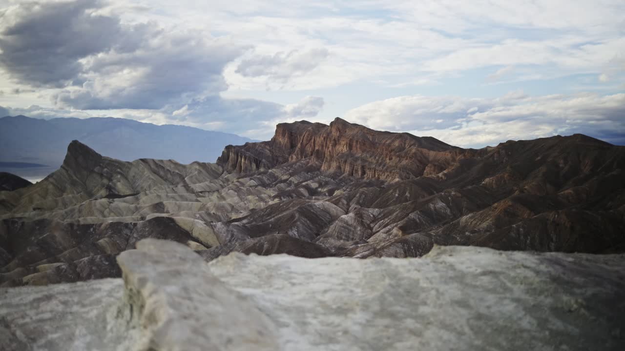 Zabriskie Point Hiker Hiking Through the Harsh Desert Terrain of Death Valley National Park