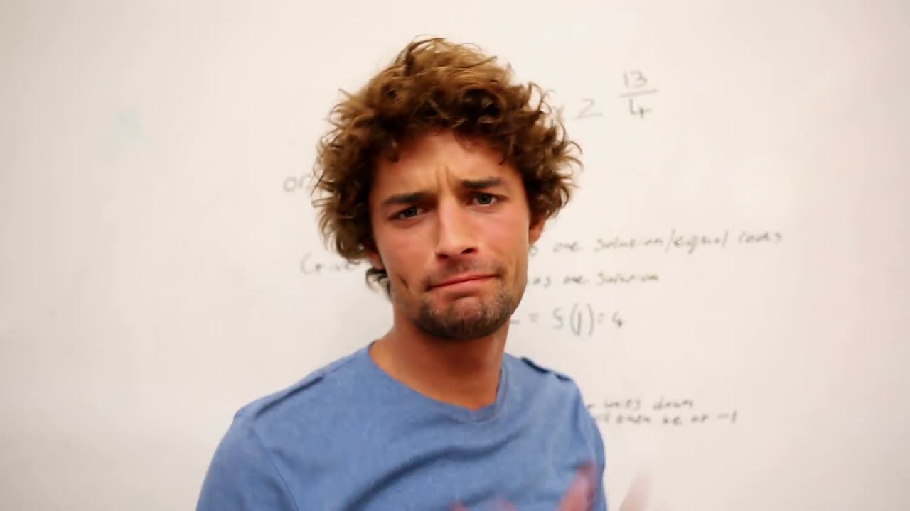 estudiante confundido de pie frente a la pizarra de matemáticas