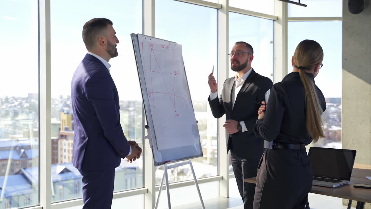 Group of young office employees. Businesspeople men and woman discussing a project in office room meeting. A team of attractive business partners.