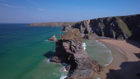 bedruthan steps in cornwall with rugged rock cliffs and sandy beaches from an aerial drone view