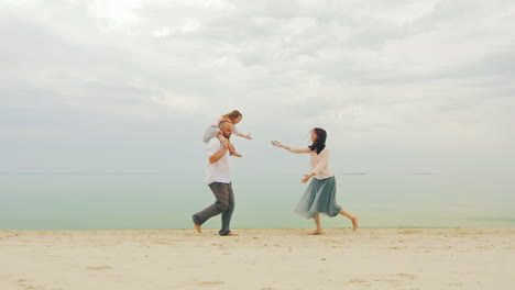 Happy-Family-Of-Three-People-Running-On-The-Beach-03