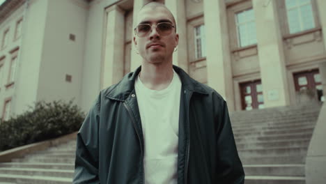 man in sunglasses on city stairs