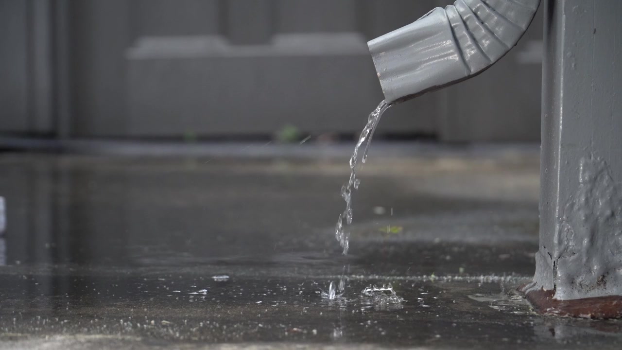 Rain water from a downspout slow motion at 24fps