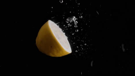 lemon falling into water super slowmotion, black background, lots of air bubbles, 4k240fps