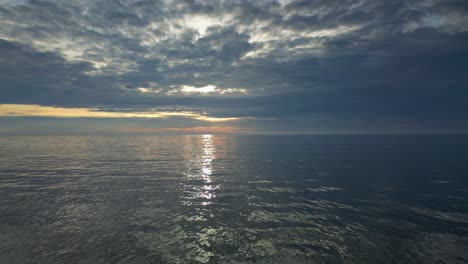 slow motion low flight over gentle sea at sunset on fleetwood beach lancashire uk