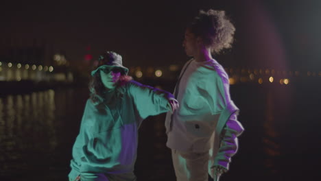 energetic young interracial couple dancing modern freestyle dance at the harbour