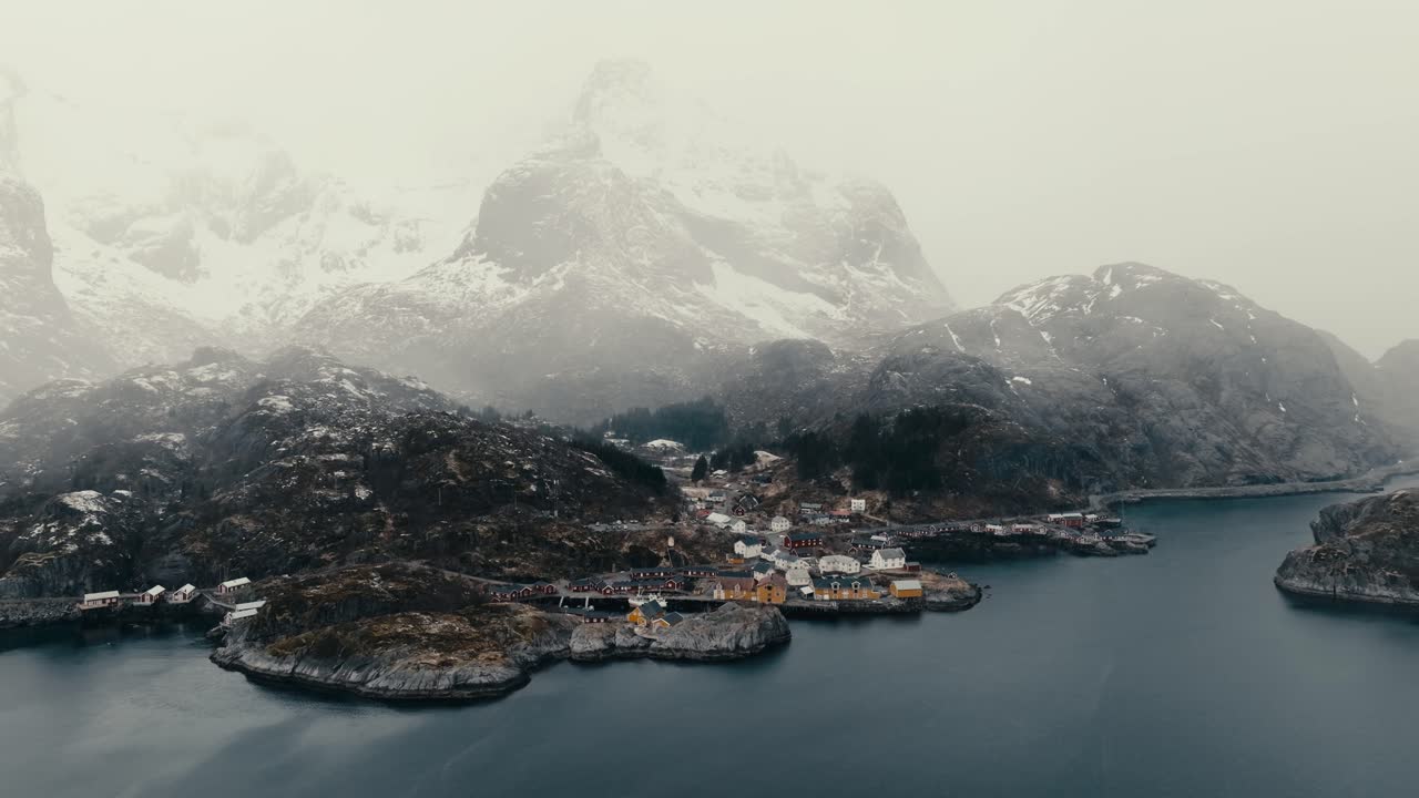 Panorama Of Misty, Snowy Mountain Above The Nusfjord Village And Vestfjorden In Winter In Flakstadoya, Norway. - aerial shot
