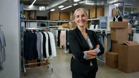 smiling woman in a clothing warehouse
