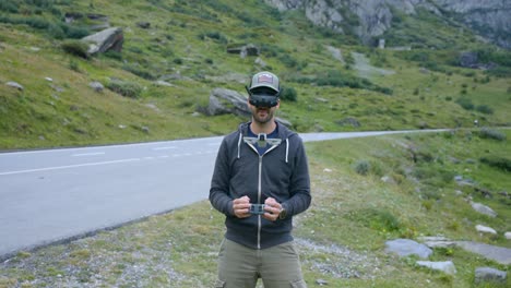 drone pilot with wireless goggles controlling neo drone in suspended flight mode