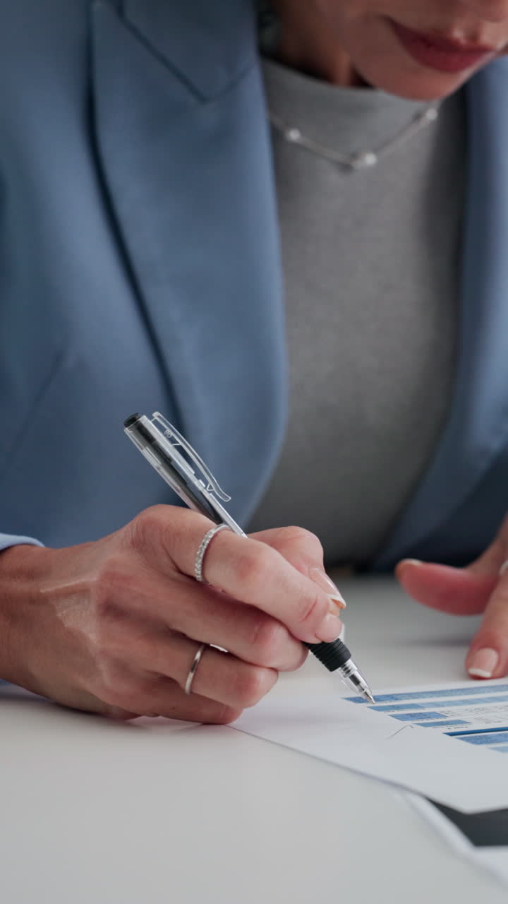Woman's Hands Writing on Documents and Typing on Laptop in Office