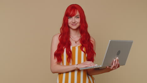 Redhead-girl-working-online-on-laptop-showing-thumb-up-positive-good-feedback,-like,-lottery-win