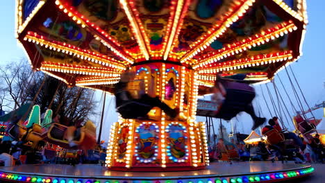 vibrant carousel swing ride at an amusement park at night