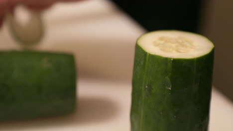 Cucumber-Being-Slice-On-A-Vertical-Position-In-The-Chopping-Board-At-The-Kitchen