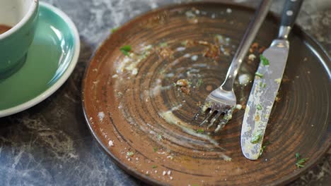 empty plate with fork and knife after breakfast