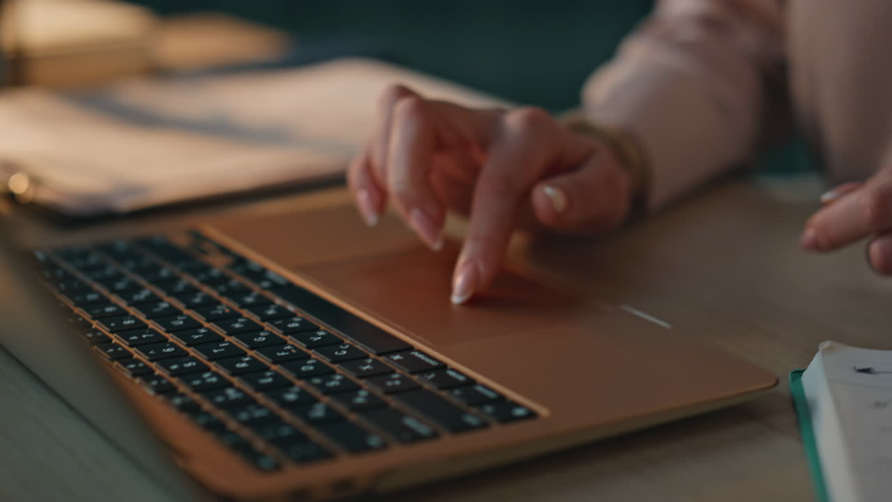 Fingers using laptop touchpad searching information online. Office worker typing