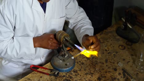 black male worker creating glass in glass factory 4k